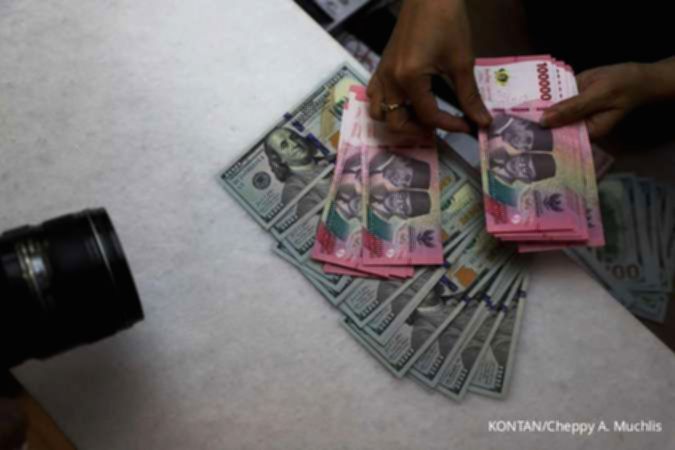 Tampilan layar monitor yang menunjukkan grafik pergerakan nilai tukar mata uang Rupiah terhadap Dolar AS.