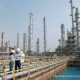 Suasana area pabrik petrokimia Chandra Asri dengan pipa-pipa industri dan tangki penyimpanan besar