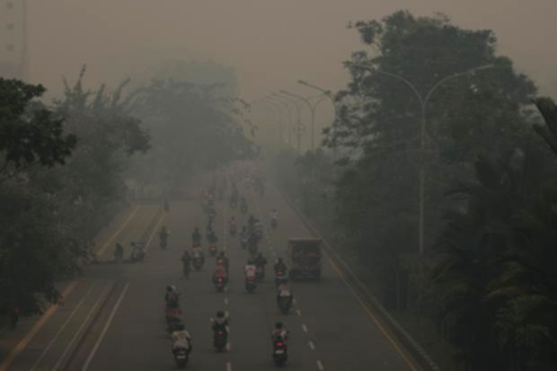 Kabut asap tebal menyelimuti kawasan pemukiman penduduk di Kalimantan akibat kebakaran hutan dan lahan.