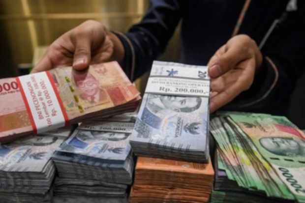 Ilustrasi mata uang rupiah Indonesia dengan latar belakang simbol dolar Amerika Serikat