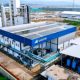 Logo PT Samator Indo Gas Tbk dengan latar belakang gedung perkantoran