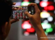 Papan layar elektronik Bursa Efek Indonesia yang menampilkan pergerakan indeks saham IHSG di Jakarta.