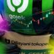 Grafik pergerakan harga saham GOTO di layar perdagangan bursa efek dengan latar belakang suasana bursa